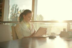 Woman at desk using tablet